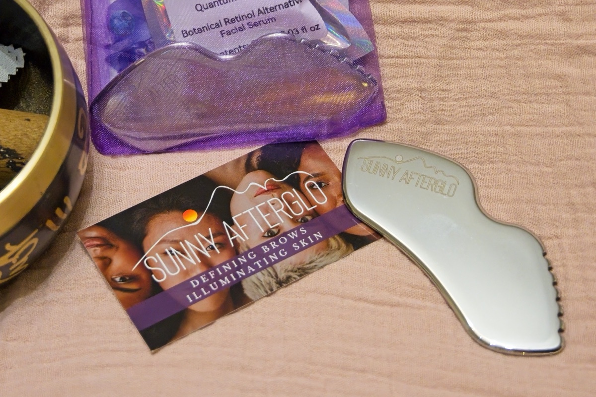 Sunny AfterGlo branded gua sha tool and skincare products